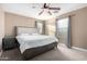 A well-lit bedroom featuring neutral walls, carpet, and a ceiling fan above the bed at 4225 E Carla Vista Dr, Gilbert, AZ 85295