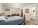 Comfortable bedroom with hardwood floors, natural light, and en-suite bathroom at 4225 N 16Th Ave, Phoenix, AZ 85015