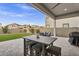 Outdoor patio and artificial grass backyard, with a table, chairs, and a covered seating area for entertaining at 4370 E Kaibab Pl, Chandler, AZ 85249