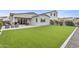A well-maintained backyard with lush artificial turf, featuring a covered patio and comfortable seating for relaxation at 4370 E Kaibab Pl, Chandler, AZ 85249
