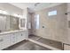 Bathroom featuring tile floor, dual sink vanity, and glass enclosed shower with modern shower head at 4370 E Kaibab Pl, Chandler, AZ 85249