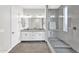 Bright bathroom featuring double sink vanity with framed mirrors and walk-in shower with glass surround at 4370 E Kaibab Pl, Chandler, AZ 85249