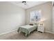 Small bedroom with neutral walls and carpet, ceiling fan, window with shutters, and white nightstand at 4370 E Kaibab Pl, Chandler, AZ 85249