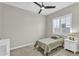 Bedroom featuring a bed, bedside table, dresser, ceiling fan and window with shutters at 4370 E Kaibab Pl, Chandler, AZ 85249