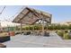 Outdoor seating area with picnic tables beneath a string-lit pavilion, creating a welcoming gathering spot at 4370 E Kaibab Pl, Chandler, AZ 85249