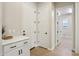 Hallway with white doors, tile flooring, and a white cabinet at 4370 E Kaibab Pl, Chandler, AZ 85249