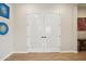 Hallway featuring white interior doors with black hardware and tile flooring at 4370 E Kaibab Pl, Chandler, AZ 85249