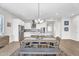 Bright kitchen with white cabinetry, stainless steel appliances and a large island and modern dining room table at 4370 E Kaibab Pl, Chandler, AZ 85249
