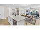 Modern kitchen island with white cabinets, stainless steel appliances, and a large island, open concept to living area at 4370 E Kaibab Pl, Chandler, AZ 85249