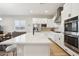 Modern kitchen features a center island, stainless appliances, white cabinetry and wood floors at 4370 E Kaibab Pl, Chandler, AZ 85249
