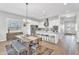 Modern kitchen with white cabinetry, stainless steel appliances and a large island and modern dining room table at 4370 E Kaibab Pl, Chandler, AZ 85249