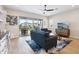 Comfortable living room with wood flooring, ceiling fan, decorative rug, and sliding glass doors to the patio at 4370 E Kaibab Pl, Chandler, AZ 85249