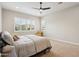 Neutral main bedroom featuring a ceiling fan, neutral carpet and a large window with plantation shutters at 4370 E Kaibab Pl, Chandler, AZ 85249