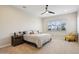 Neutral main bedroom featuring a ceiling fan, neutral carpet and a large window with plantation shutters at 4370 E Kaibab Pl, Chandler, AZ 85249