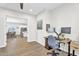Office with desk setup, neutral paint, and hardwood floors opening into dining and kitchen at 4370 E Kaibab Pl, Chandler, AZ 85249