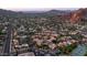 Wide aerial shot showcasing community featuring residential housing, desert landscaping, and nearby mountains at 4434 E Camelback Rd # 128, Phoenix, AZ 85018