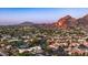 Scenic aerial view of homes nestled in desert landscape with mountains in background featuring a pin marking home for sale at 4434 E Camelback Rd # 128, Phoenix, AZ 85018