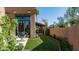 Backyard view of patio area, artificial turf, mature trees and desert landscaping, creating a serene outdoor space at 4434 E Camelback Rd # 128, Phoenix, AZ 85018