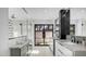 Modern bathroom with double vanities, marble countertops, and walk-in shower. Features large windows to backyard at 4434 E Camelback Rd # 128, Phoenix, AZ 85018