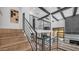 Open entryway with wood and metal staircase, offering views of living spaces and backyard at 4434 E Camelback Rd # 128, Phoenix, AZ 85018