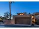 Exterior view of home featuring a multi-car garage, desert landscaping, and modern architecture at 4434 E Camelback Rd # 128, Phoenix, AZ 85018