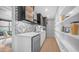 Modern kitchen with white cabinets, stainless steel appliances, pantry, and decorative backsplash at 4434 E Camelback Rd # 128, Phoenix, AZ 85018