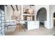 Elegant kitchen island with modern stools, a stunning chandelier, and stainless steel appliances at 4434 E Camelback Rd # 128, Phoenix, AZ 85018