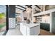 Open-concept kitchen with a large island, stainless steel appliances, and living area in background at 4434 E Camelback Rd # 128, Phoenix, AZ 85018