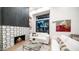 Bright living room with a fireplace, modern tile work, and large windows at 4434 E Camelback Rd # 128, Phoenix, AZ 85018