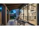 Inviting outdoor dining area with covered patio, tile flooring, and large sliding glass doors to indoor living space at 4434 E Camelback Rd # 128, Phoenix, AZ 85018