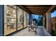 Inviting outdoor dining space with table and chairs situated on tile patio looking in through sliding glass doors to indoor space at 4434 E Camelback Rd # 128, Phoenix, AZ 85018