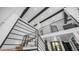 View of the wooden staircase and black metal railing in this modern home with soaring ceilings at 4434 E Camelback Rd # 128, Phoenix, AZ 85018