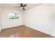 Bright, empty bedroom with modern fan, neutral walls and simple window at 4721 N 24Th St, Phoenix, AZ 85016