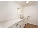 Bright laundry room with white cabinetry, quartz countertops and stainless steel faucet and hookups for washer and dryer at 4721 N 24Th St, Phoenix, AZ 85016