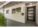 Inviting front porch with white brick, dark door, stylish house numbers, and a lush green bush at 4729 N 24Th St, Phoenix, AZ 85016