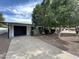 Charming single-story home featuring a black garage door, well-maintained landscaping, and mature trees at 4729 N 24Th St, Phoenix, AZ 85016