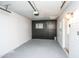 Clean, well-lit garage featuring painted walls, a sleek painted floor, and an automatic garage door opener at 4729 N 24Th St, Phoenix, AZ 85016