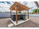Hot tub under a wooden pergola in a gravel backyard at 4729 N 24Th St, Phoenix, AZ 85016