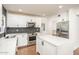 Well-designed kitchen with stainless steel appliances, white cabinets, a central island and dark backsplash at 4729 N 24Th St, Phoenix, AZ 85016