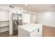 Spacious kitchen with a stainless steel refrigerator and a white island with dark hardware at 4729 N 24Th St, Phoenix, AZ 85016