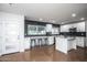 Bright, open kitchen with white cabinetry, modern appliances, large windows and a center island with seating at 4729 N 24Th St, Phoenix, AZ 85016