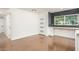 Open-concept living room with a built-in desk, polished concrete floors, and abundant natural light at 4729 N 24Th St, Phoenix, AZ 85016