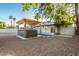 Backyard featuring a covered hot tub area and landscaped surroundings at 4735 N 24Th St, Phoenix, AZ 85016