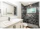 Modern bathroom with a stylish black marble shower and a bright vanity with undermount sink at 4735 N 24Th St, Phoenix, AZ 85016