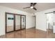 Bedroom with mirrored closet doors, modern ceiling fan, and ensuite bathroom at 4735 N 24Th St, Phoenix, AZ 85016