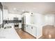 Modern kitchen with stainless steel appliances, herringbone backsplash, and white cabinets at 4735 N 24Th St, Phoenix, AZ 85016