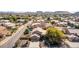 Aerial view of a community featuring lush landscaping, tile roofs, and well-maintained streets at 4937 W Desert Hollow Dr, Phoenix, AZ 85083