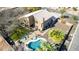 Aerial view of landscaped backyard with pool, patio, and lush surrounding greenery at 4937 W Desert Hollow Dr, Phoenix, AZ 85083