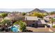 Aerial view of a home showcasing a private pool, landscaped yard, and mountain views at 4937 W Desert Hollow Dr, Phoenix, AZ 85083