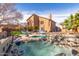 Expansive backyard features a hot tub, lounge chairs, lush greenery, and well-maintained landscaping at 4937 W Desert Hollow Dr, Phoenix, AZ 85083